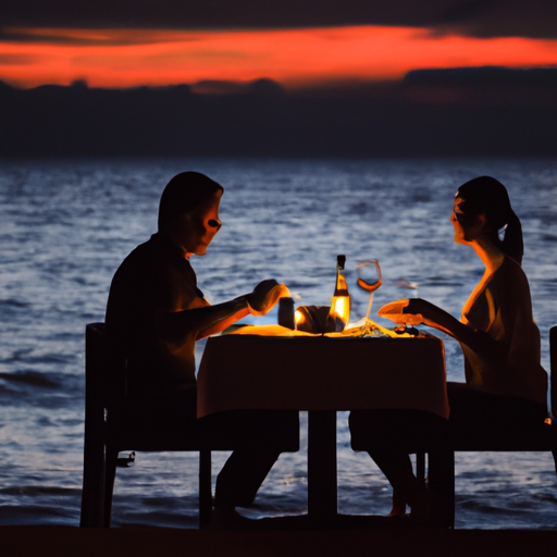 זוג נהנה מארוחת ערב רומנטית על שפת הים